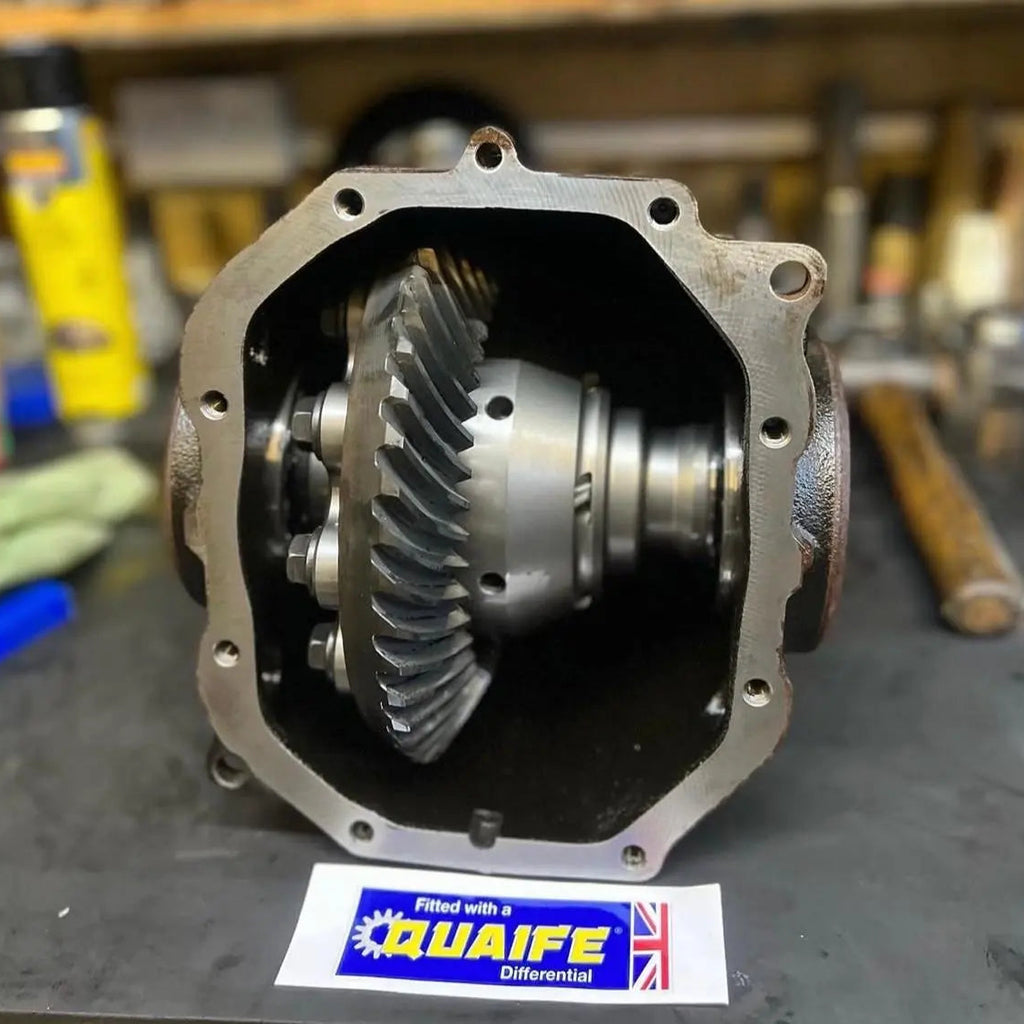 Quaife differential gear on a workshop bench with tools in the background